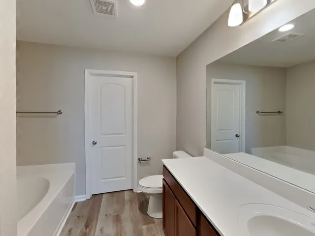 a bathroom with a sink a toilet and bathtub