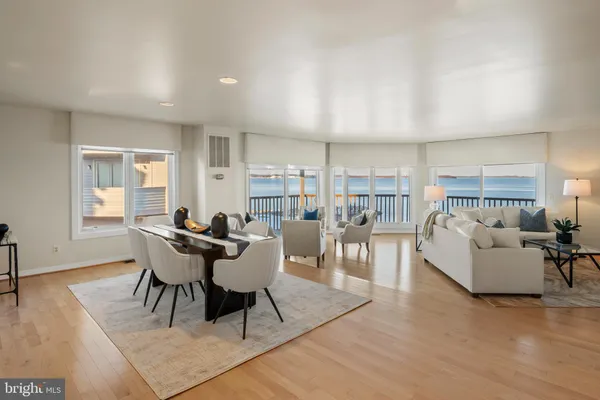 a view of a dining room with furniture and a large window