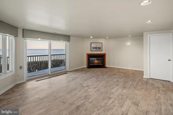 a view of a lake with a building and trees in the background