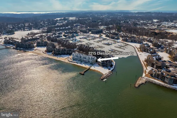 a view of a house with a big yard and large trees