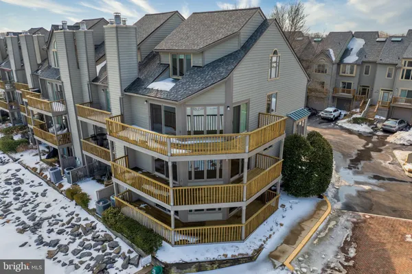 a view of a house with a wooden fence