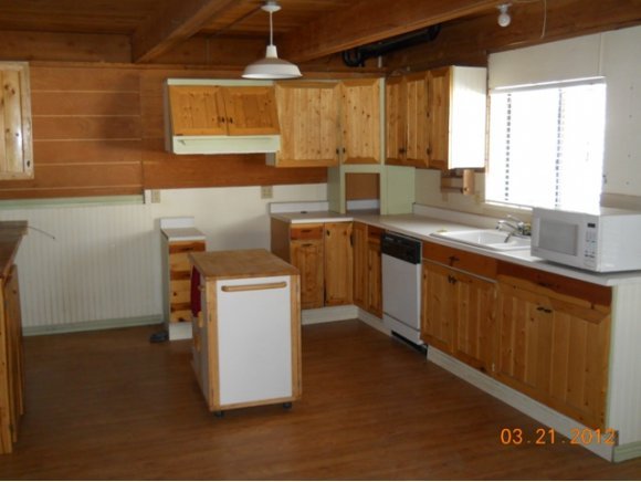 8255 South Breezy Pine Road Mayer, AZ 86333 - Photo 3 of 12 a kitchen with a sink stove and cabinets