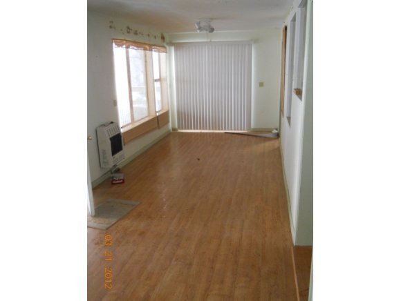 8255 South Breezy Pine Road Mayer, AZ 86333 - Photo 5 of 12 a view of an empty room with wooden floor and a window