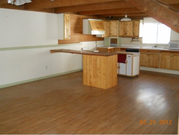 8255 South Breezy Pine Road Mayer, AZ 86333 - Photo 10 of 12 a kitchen with stainless steel appliances granite countertop a sink and cabinets with wooden floor