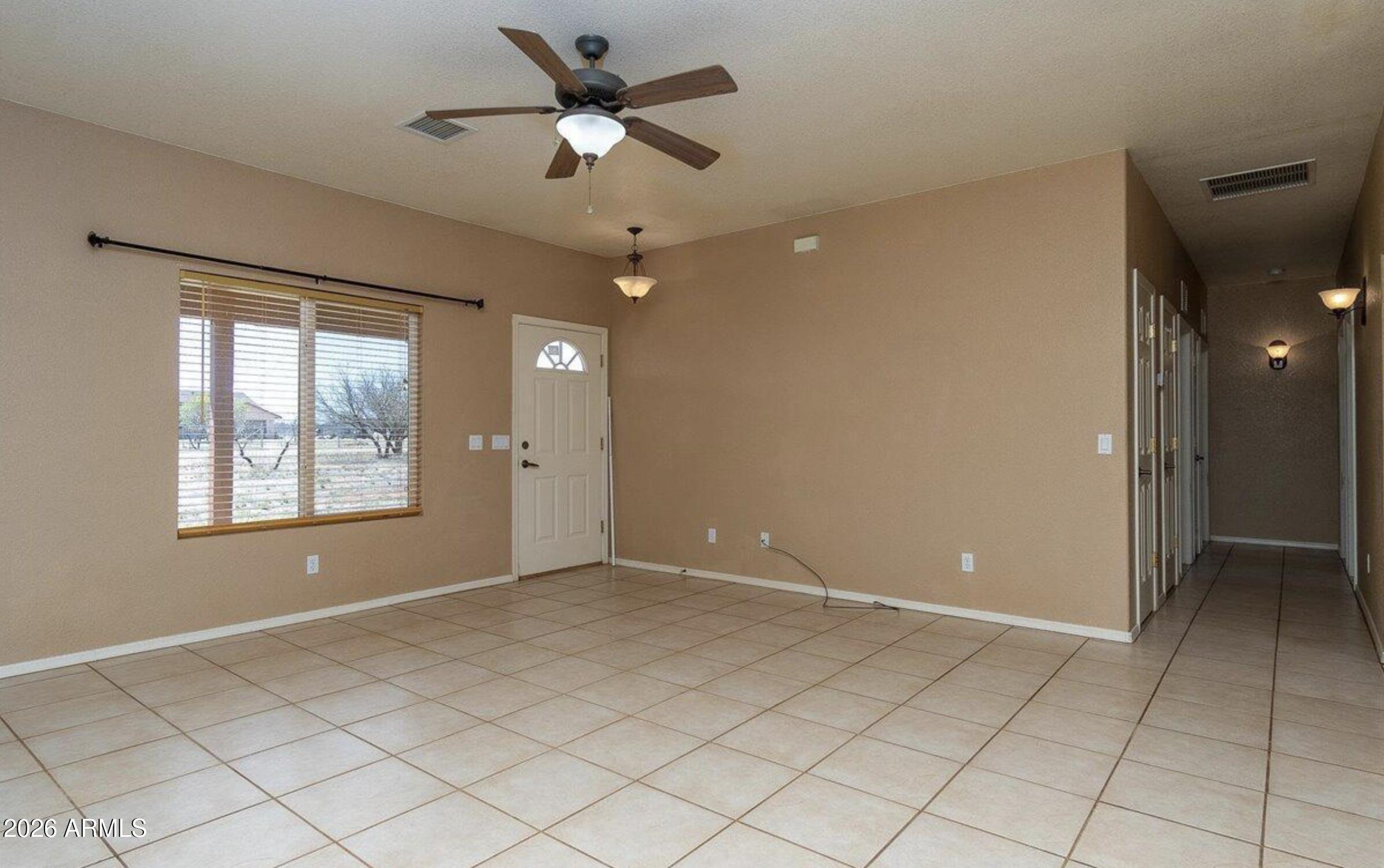 10193 East Windtalker Road Hereford, AZ 85615 - Photo 8 of 34 a view of an empty room with a window