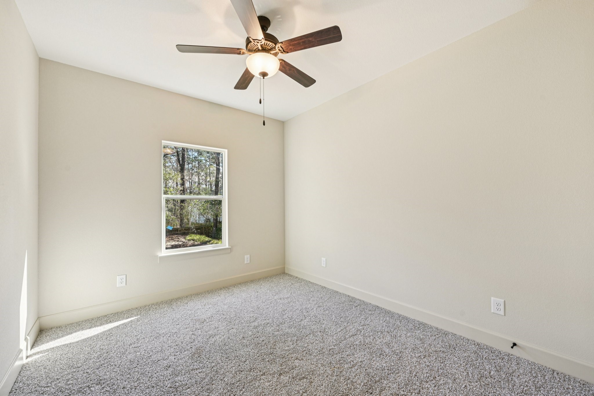 15132 Coaltown Road Willis, TX 77378 - Photo 19 of 29 Third bedroom with carpeting, a ceiling fan, and a window offering a view of the outdoors.
