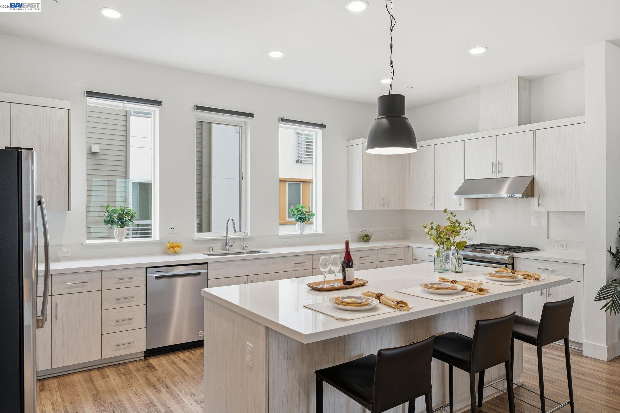 7906 Regional Common Dublin, CA 94568 - Photo 13 of 40 a kitchen with a sink a stove and chairs