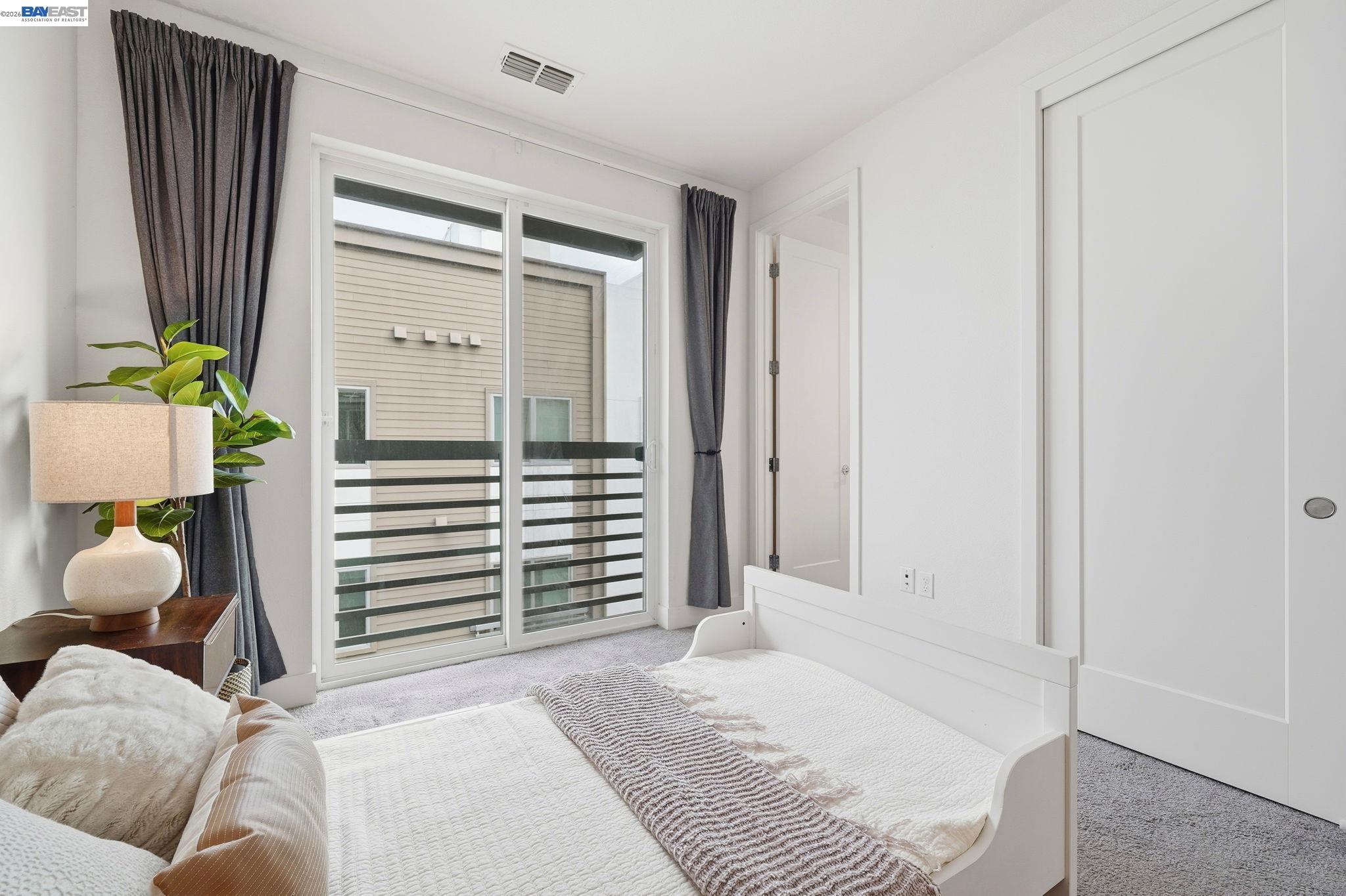 7906 Regional Common Dublin, CA 94568 - Photo 18 of 40 a bedroom with a bed and a window