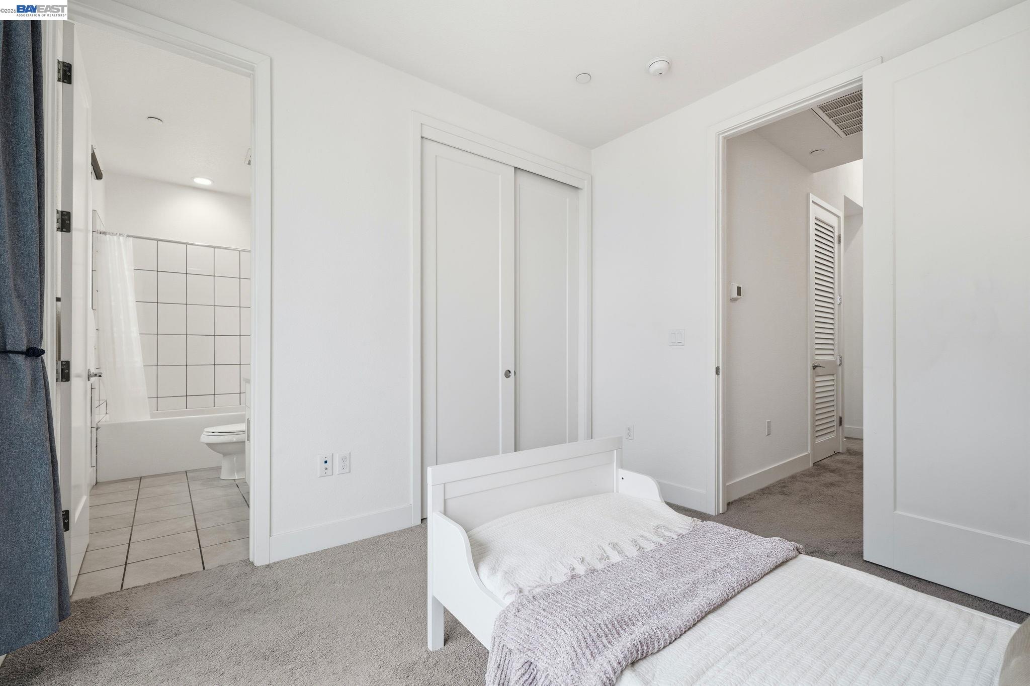 7906 Regional Common Dublin, CA 94568 - Photo 19 of 40 a bedroom with a bed and a bathroom