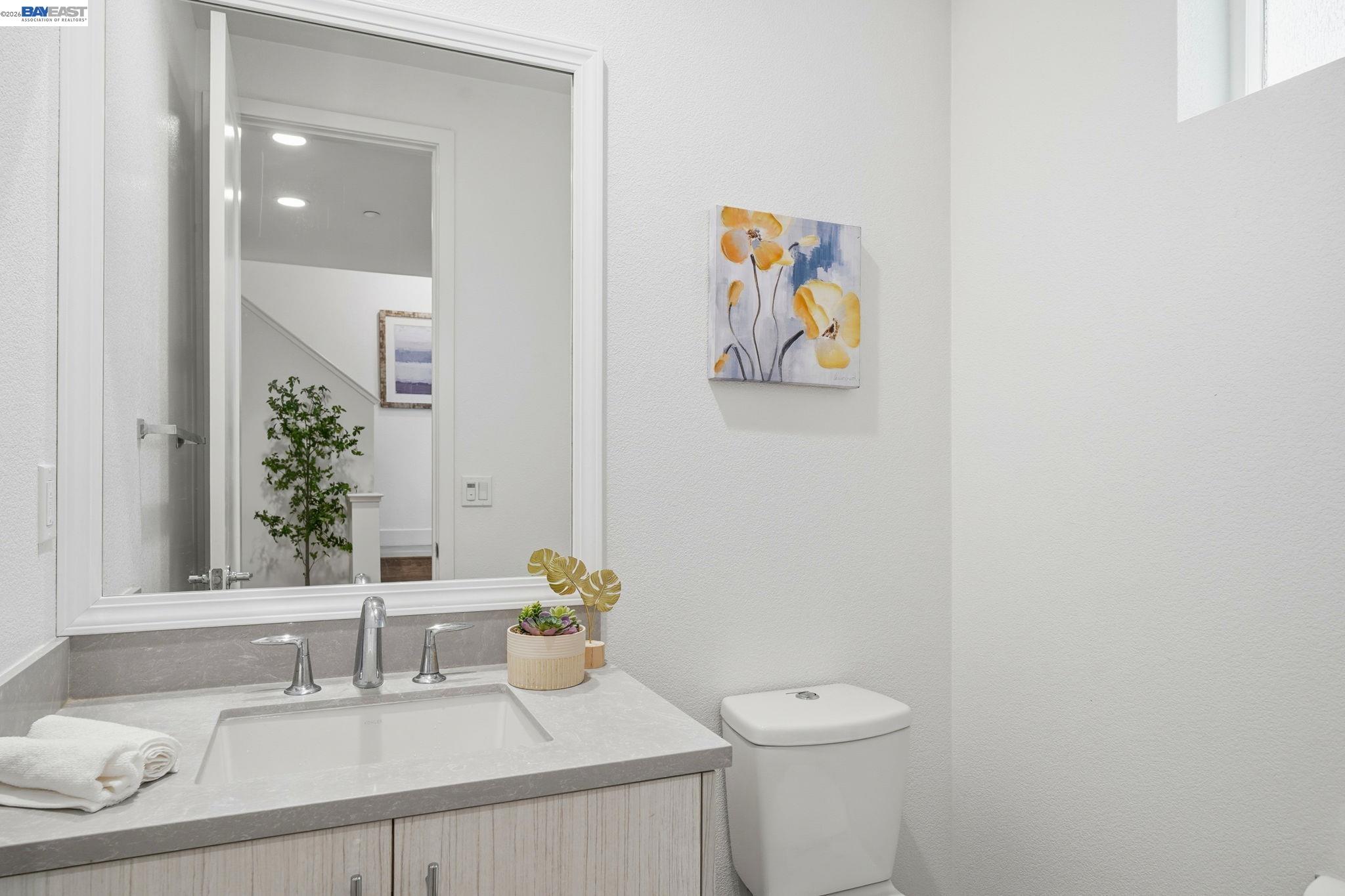 7906 Regional Common Dublin, CA 94568 - Photo 25 of 40 a bathroom with a granite countertop sink and a mirror