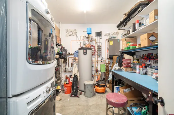a storage room with lots of clutter and cabinets
