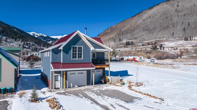 a view of a house with a snow in the yard