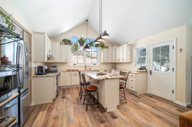 a kitchen with a sink a counter top space and appliances