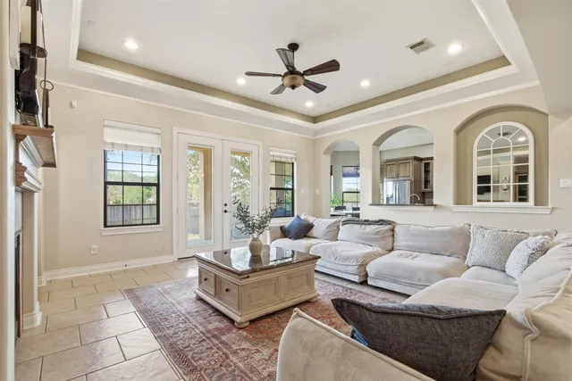 a kitchen with stainless steel appliances granite countertop a refrigerator a stove a sink dishwasher a dining table and chairs with wooden floor