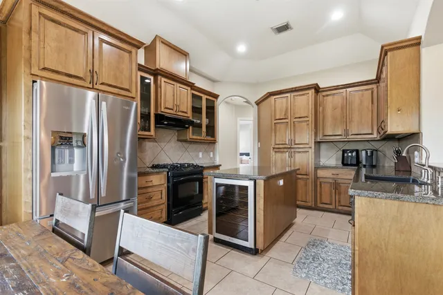a large kitchen with cabinets and stainless steel appliances