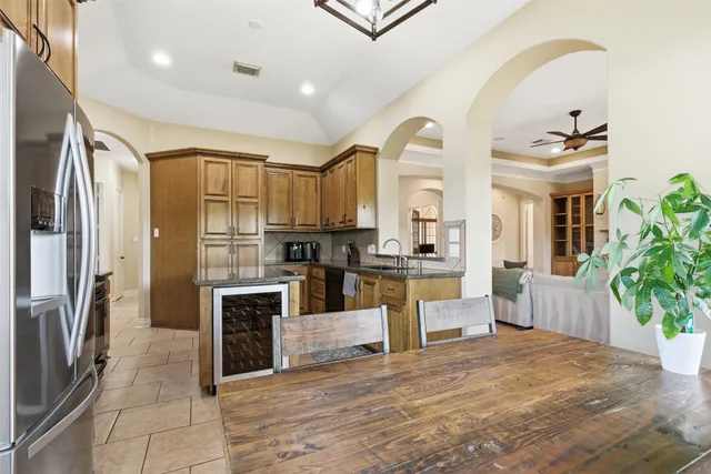 a large kitchen with kitchen island a sink stove and cabinets