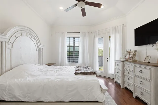 a bedroom with a bed and a flat screen tv