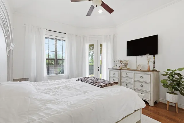 a bedroom with a bed and a flat screen tv