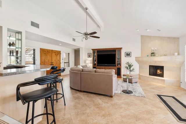 a living room with furniture a fireplace and a flat screen tv