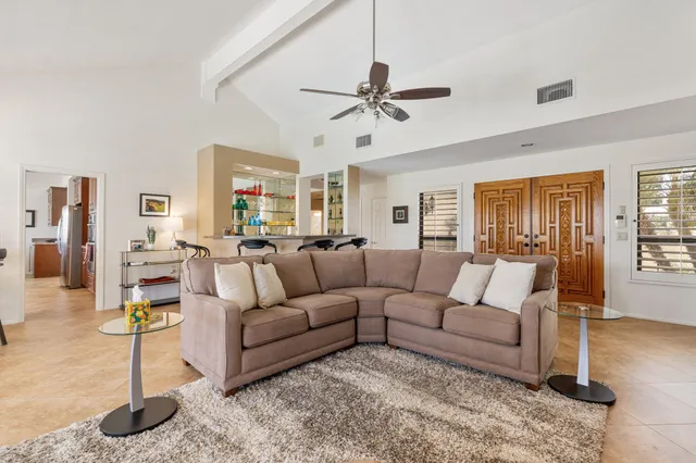 a living room with furniture and a chandelier