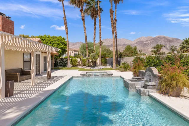 a swimming pool with outdoor seating and yard