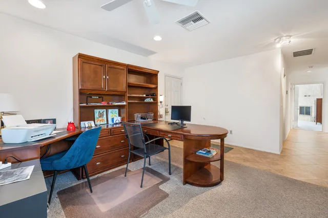 a view of a workspace with furniture