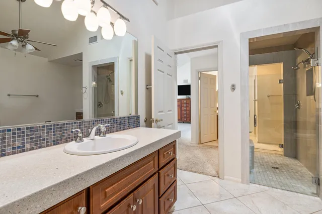 a bathroom with a sink double vanity and a mirror