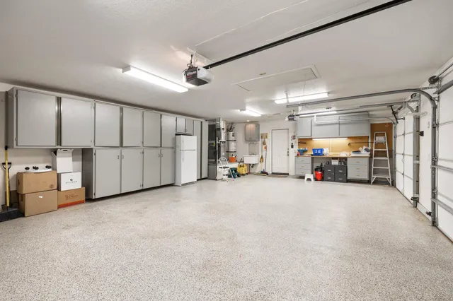 a bathroom with a granite countertop sink a mirror and a light fixture