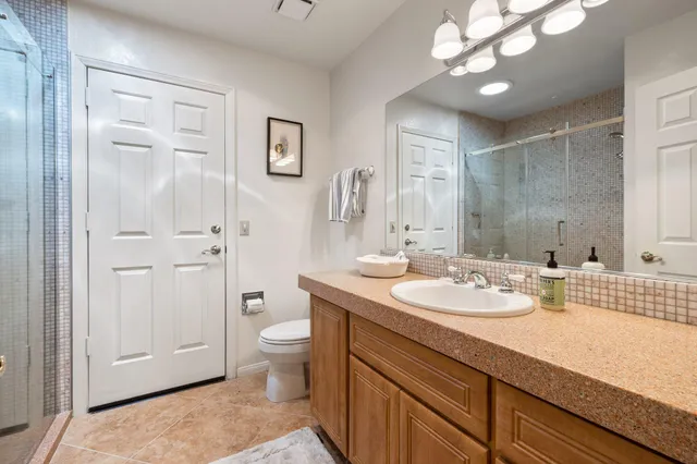 a bathroom with a glass shower door