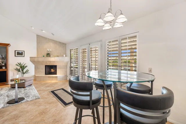 a living room with furniture a fireplace and a chandelier