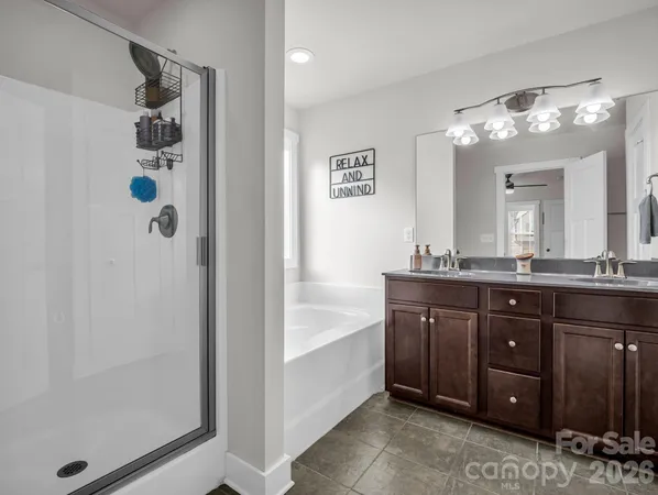 a bathroom with a granite countertop sink a mirror and a shower