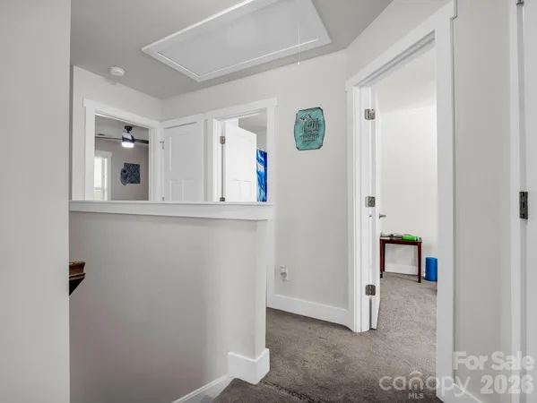 an entryway with wooden floor and cabinet