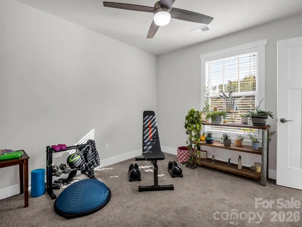a room with gym equipment and a large window