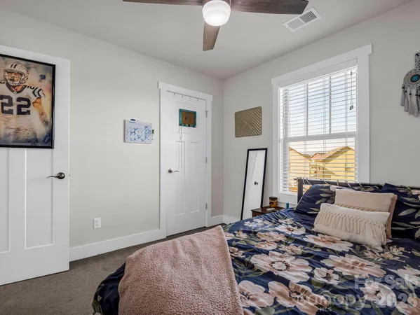 a bedroom with a large bed and a window