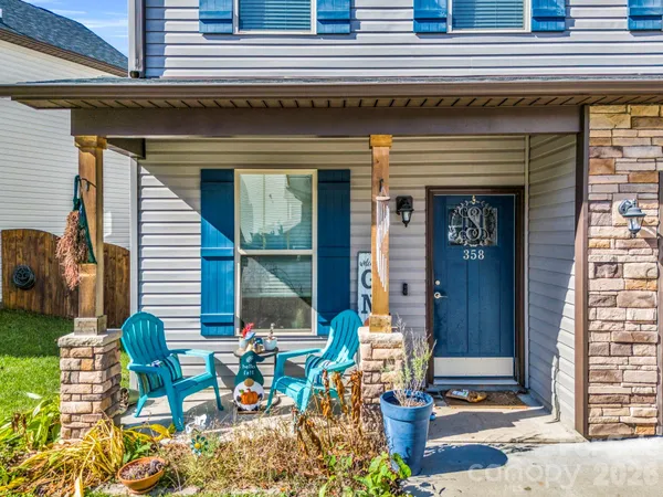 a view of a patio with table and chairs and potted plants