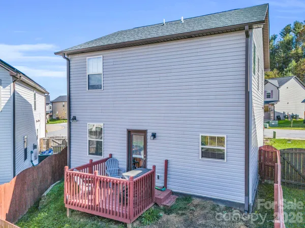 a view of a house with a wooden deck