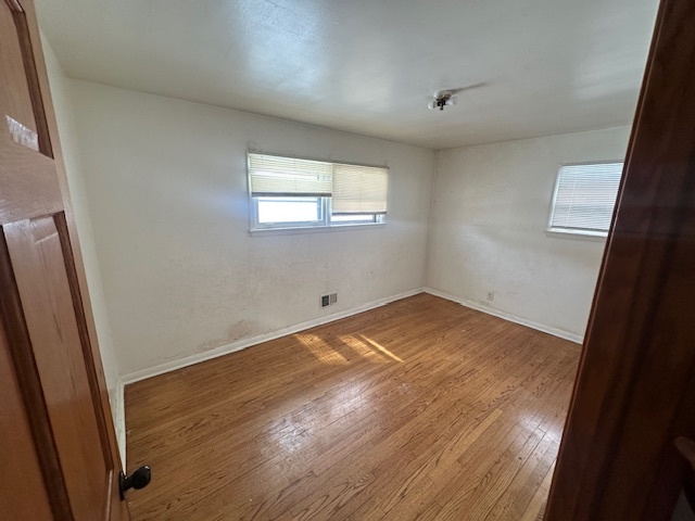 519 North Forest Avenue Mount Prospect, IL 60056 - Photo 12 of 20 an empty room with wooden floor and windows