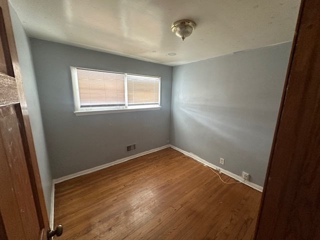 519 North Forest Avenue Mount Prospect, IL 60056 - Photo 6 of 20 an empty room with wooden floor and windows