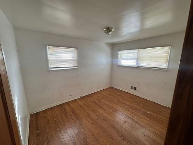519 North Forest Avenue Mount Prospect, IL 60056 - Photo 7 of 20 an empty room with wooden floor and windows