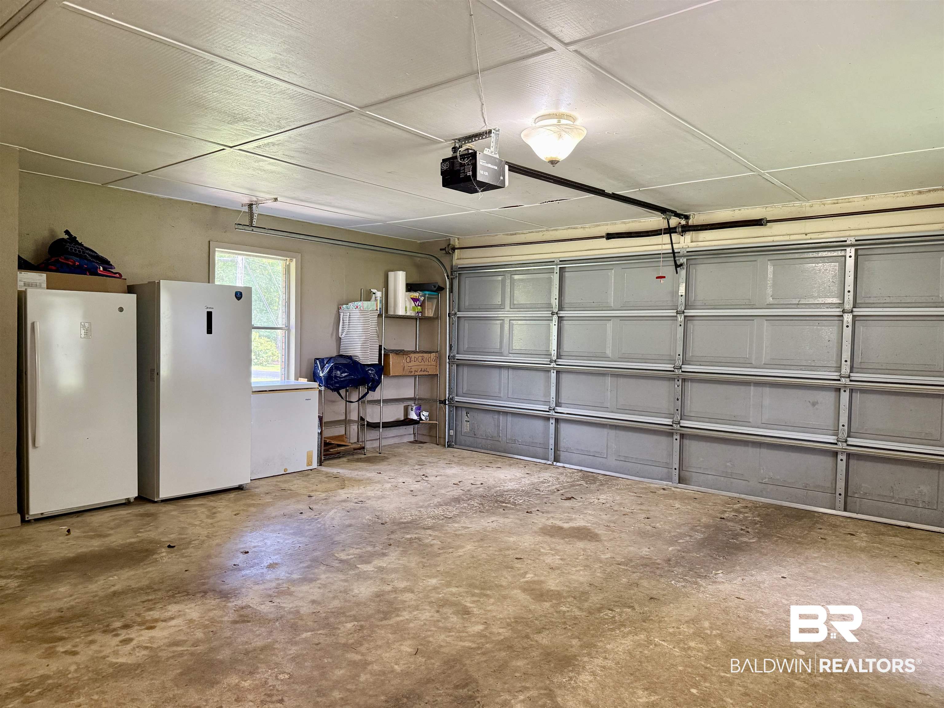 5971 Appleton Road Brewton, AL 36426 - Photo 18 of 23 Garage with freestanding refrigerator and a garage door opener