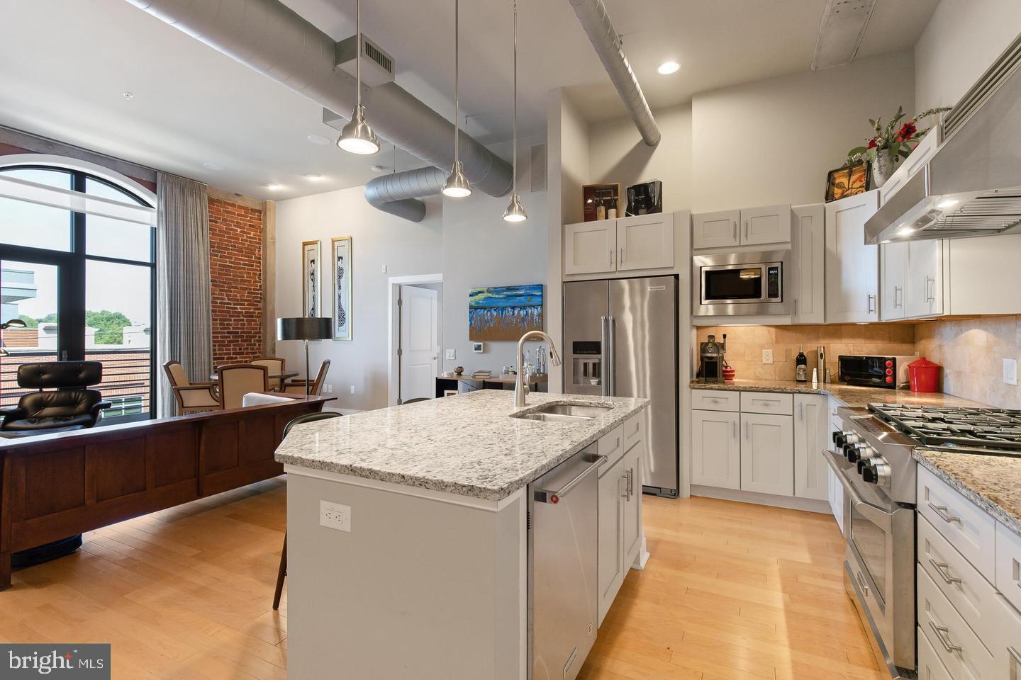 41 West Lemon Street, Unit 401 Lancaster, PA 17603 - Photo 7 of 22 a kitchen with stainless steel appliances granite countertop a sink stove and refrigerator