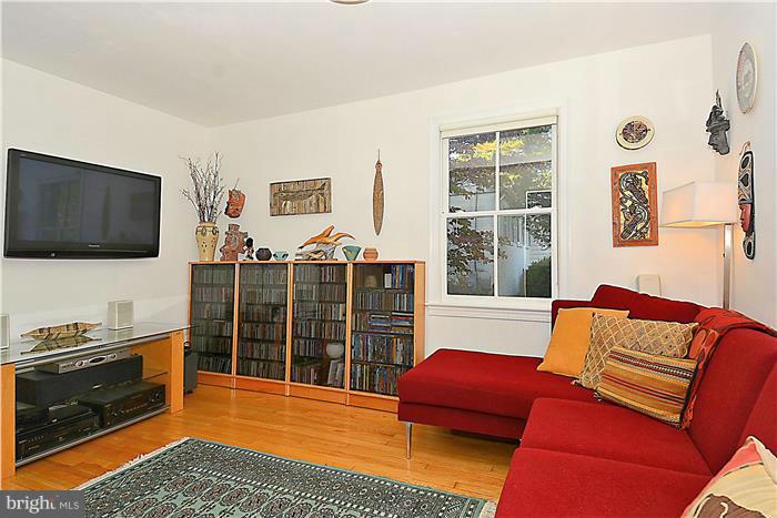 9206 Saybrook Avenue Silver Spring, MD 20901 - Photo 12 of 30 a living room with furniture a flat screen tv and a window