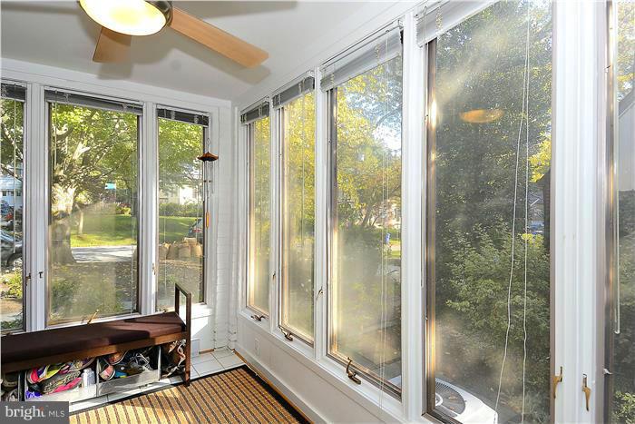 9206 Saybrook Avenue Silver Spring, MD 20901 - Photo 13 of 30 a room with outdoor seating and a floor to ceiling window
