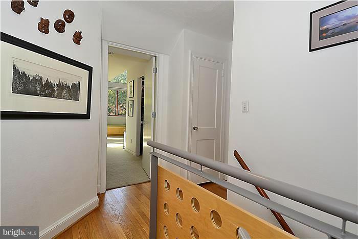9206 Saybrook Avenue Silver Spring, MD 20901 - Photo 15 of 30 a view of a hallway with paintings on the wall