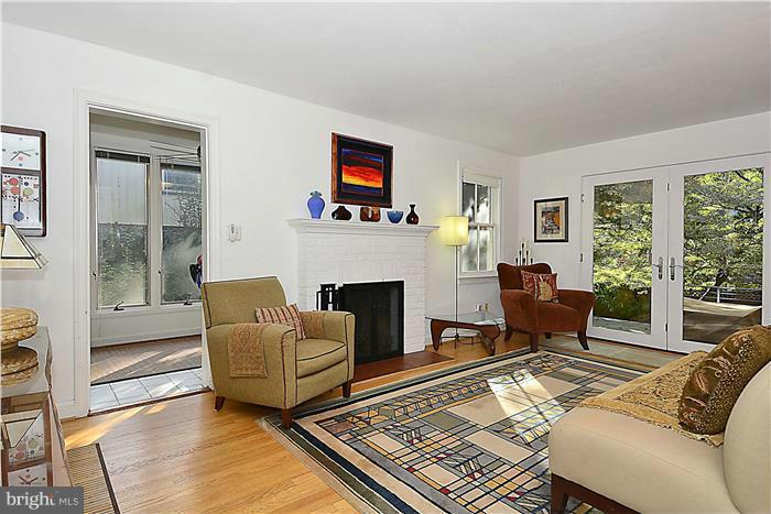 9206 Saybrook Avenue Silver Spring, MD 20901 - Photo 3 of 30 a living room with furniture a flat screen tv and a fireplace