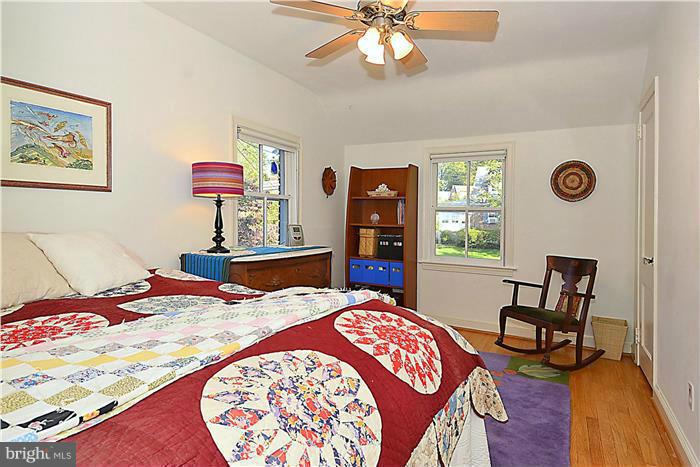 9206 Saybrook Avenue Silver Spring, MD 20901 - Photo 21 of 30 a bedroom with a bed and a lamp on dresser