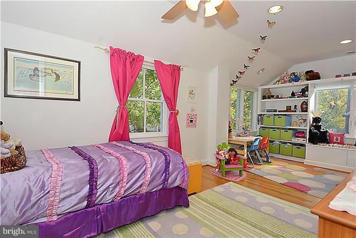 9206 Saybrook Avenue Silver Spring, MD 20901 - Photo 22 of 30 a bedroom with a bed and a book shelf