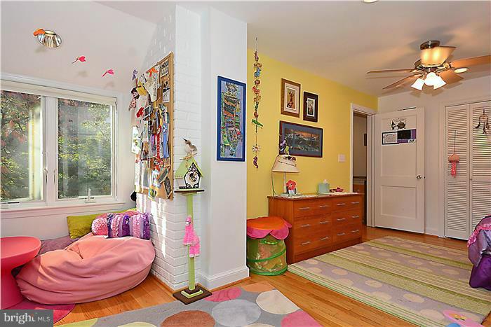 9206 Saybrook Avenue Silver Spring, MD 20901 - Photo 23 of 30 a bedroom with a bed and a chandelier