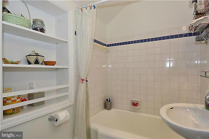 9206 Saybrook Avenue Silver Spring, MD 20901 - Photo 26 of 30 a bathroom with a bathtub and a shower