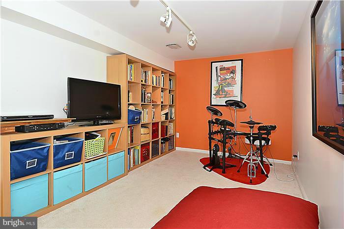 9206 Saybrook Avenue Silver Spring, MD 20901 - Photo 27 of 30 a room with furniture and flat screen tv